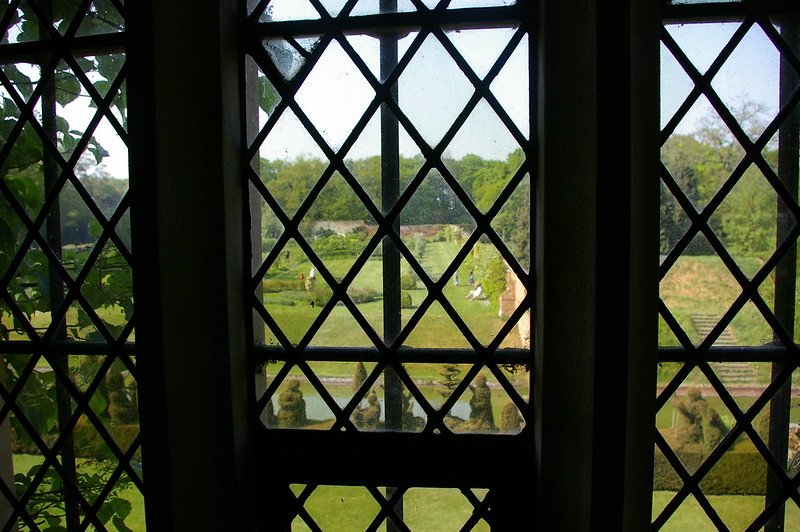 The gardens of Kentwell Hall, Suffolk, seen through one of its windows